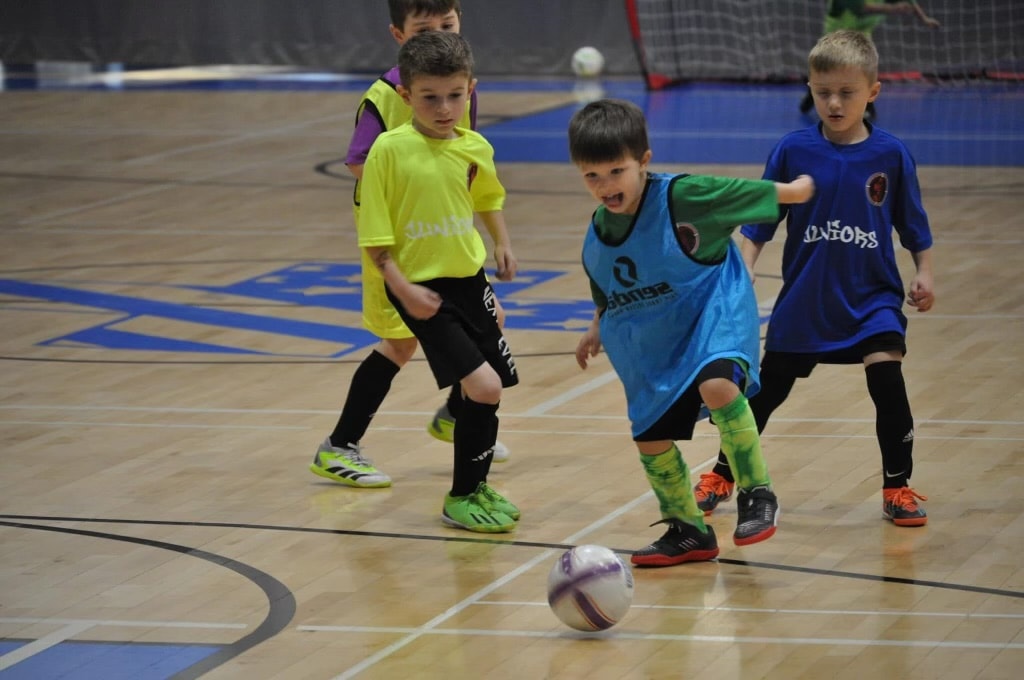 Juniors playing indoor futsal